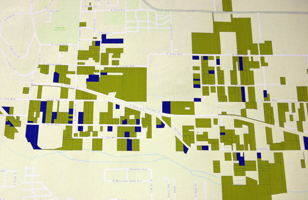 A map of East Porterville at the county's drought resource center shows homes without running water (green) and homes where large tanks have been installed as an interim solution (blue). 