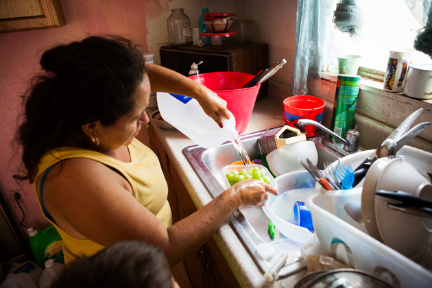 Juana Garcia washes grapes with bottled water. She soaks dirty dishes in soapy water before rinsing them to minimize water use. 