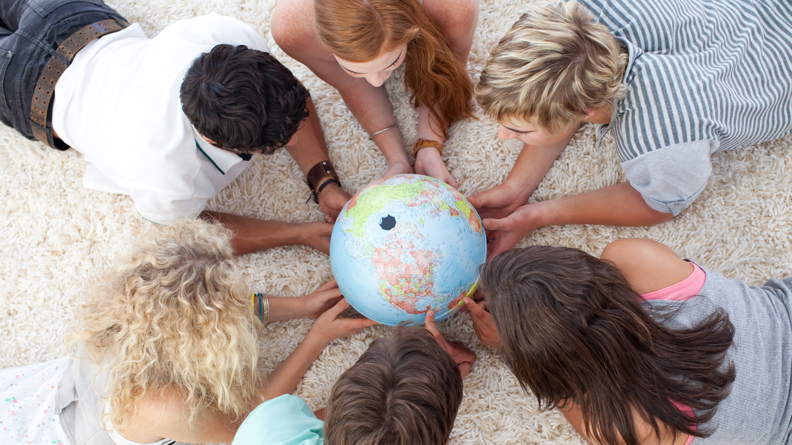 Teenagers with a globe