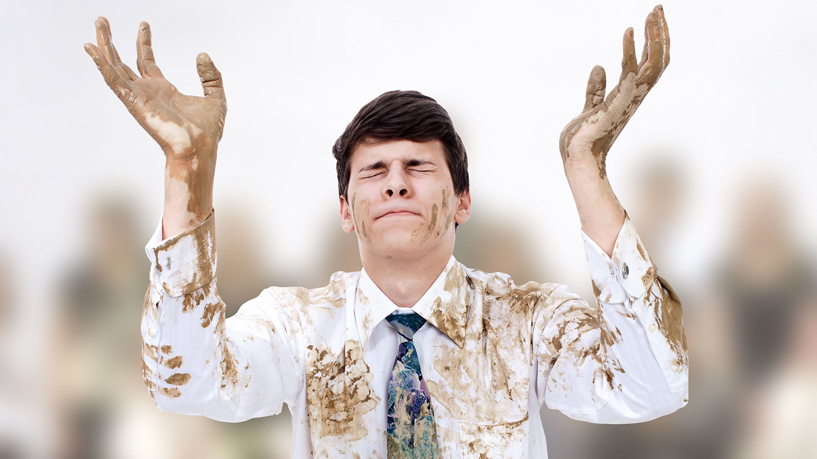 Young man raising hands and praying to the Dry Cleaning Gods