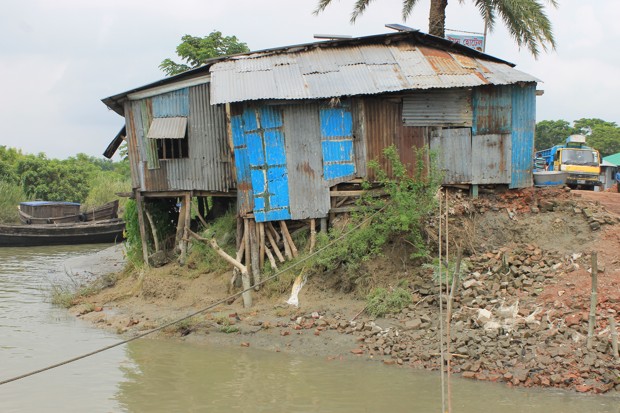 The role of climate migration in the COP21 agreement is precarious, much like this structure perched on the receding shoreline of Bhola.