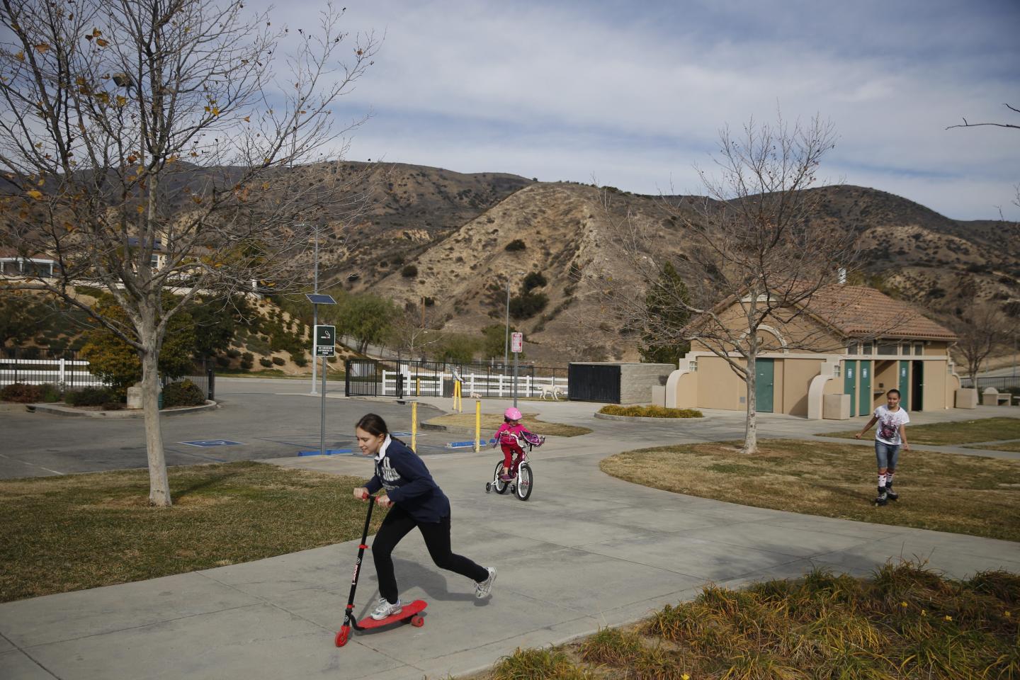 From left, Shannon Waldman, 12, Cameron Waldman, 6, and Katherine Waldman play in Holleigh Bernson Memorial Park, Jan. 3.