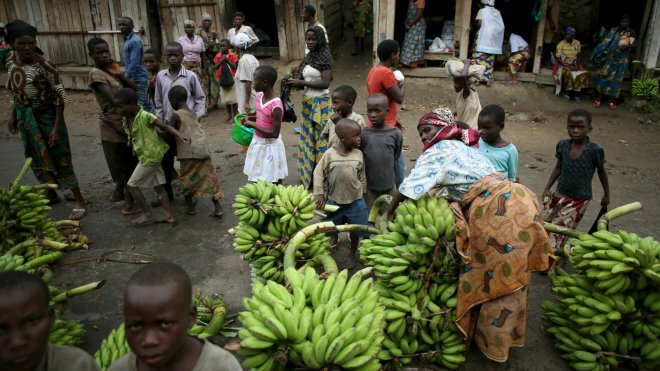 People sell bananas in an open market in a village near Bujumbura, Burundi