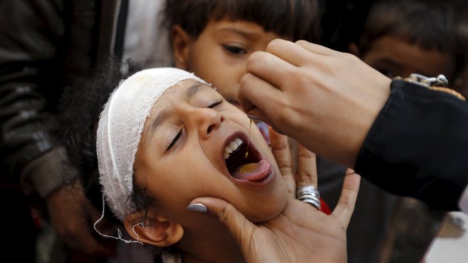 A boy gets vitamin A drops at a school in Yemen