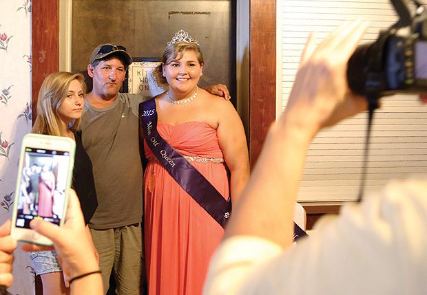 A recent winner of the Titusville, Penn., pageant poses with family members.