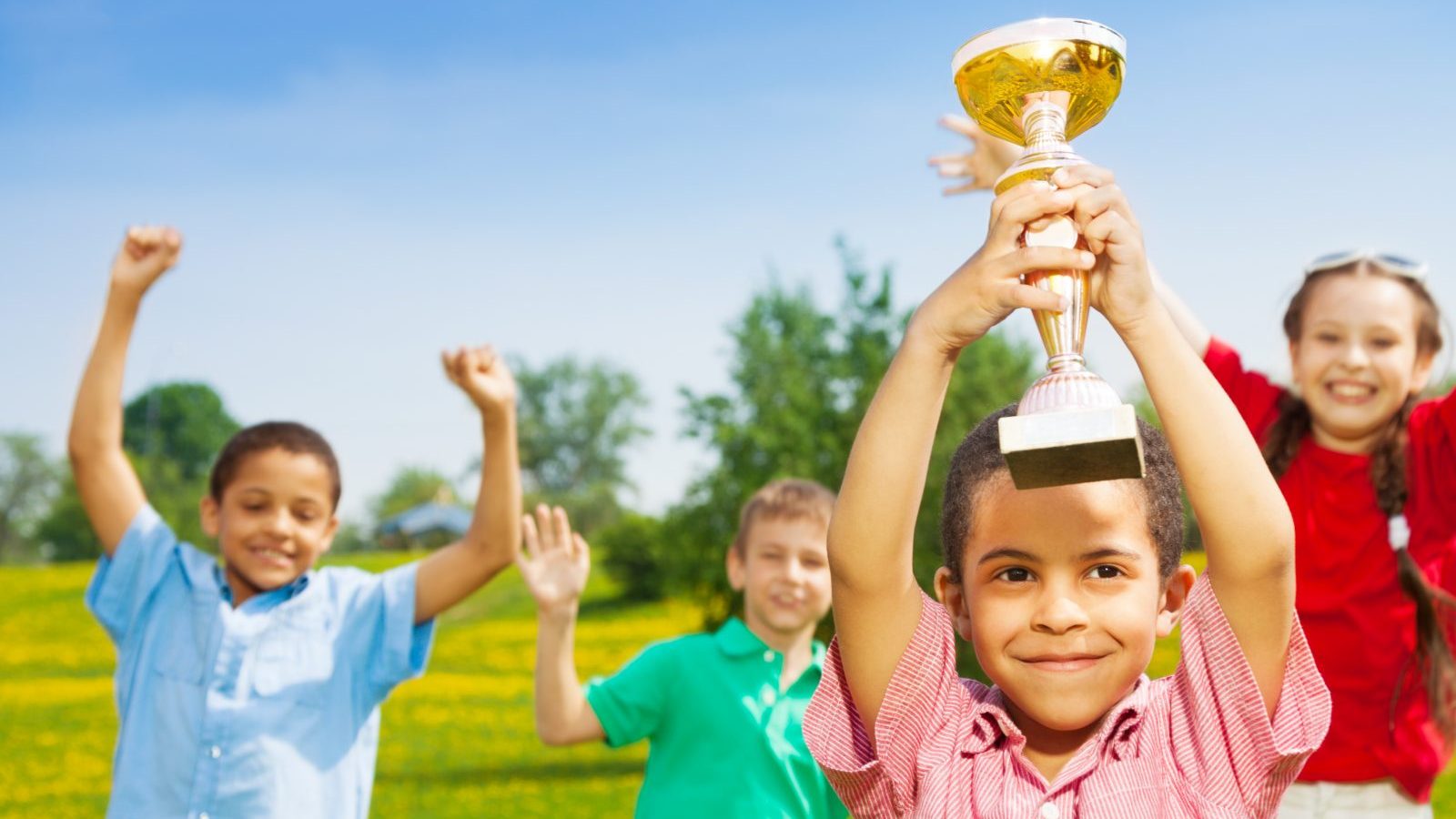 Happy kids with a trophy.