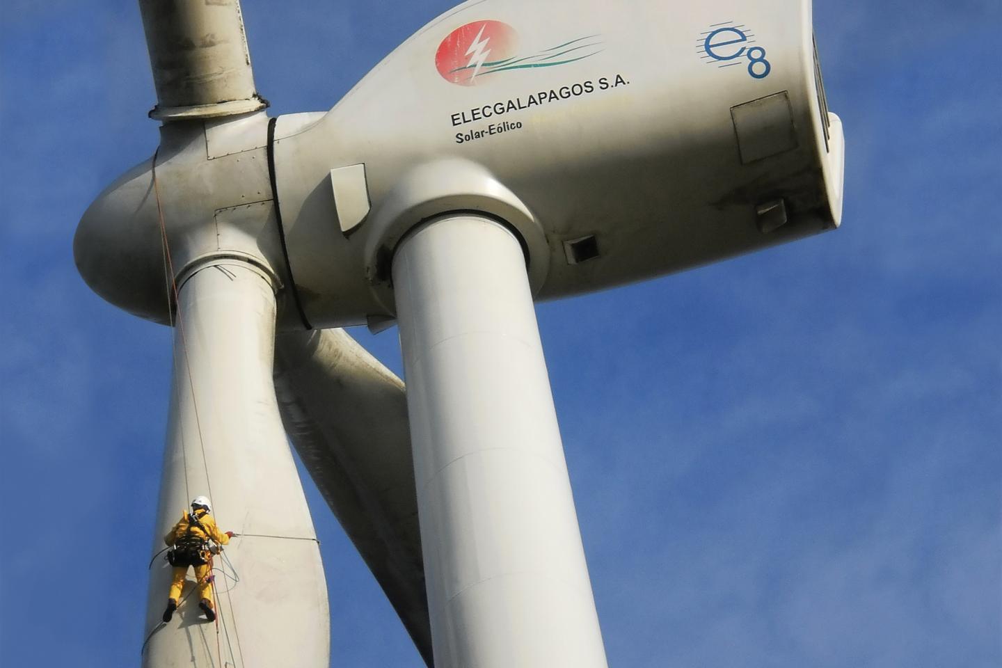 Workers clean the blades on a wind turbine on San Cristóbal Island in the Galapagos. The turbine provides 30 percent of the electricity consumed on San Cristóbal, replacing 2.3 million gallons of diesel fuel and avoiding 21,000 tons of carbon dioxide emissions.