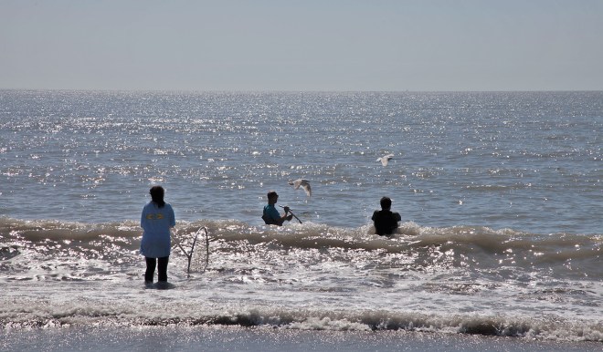 Salmon fishermen work at the mouth of the Chuitna.