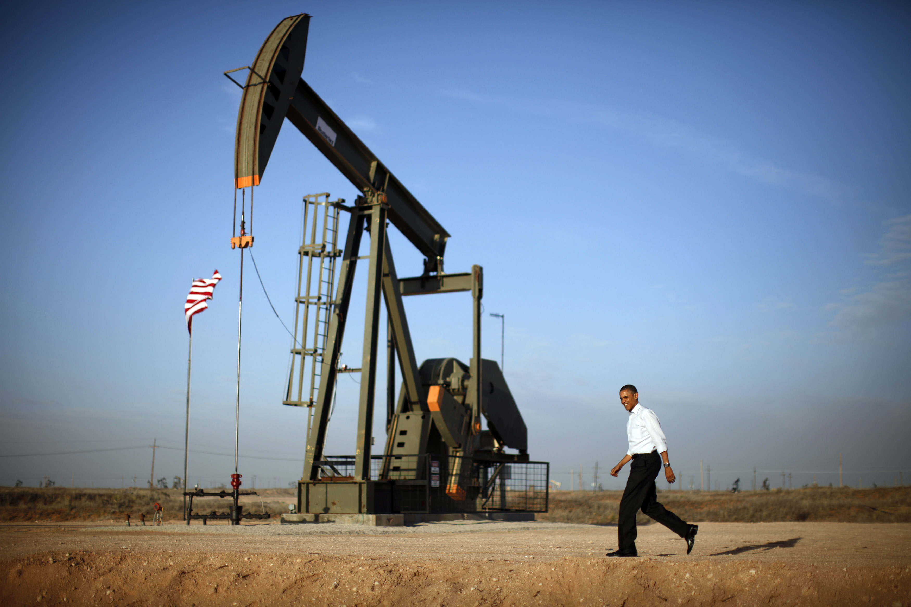 U.S. President Barack Obama walks past a pumpjack on his way to deliver remarks on energy independence at Maljamar Cooperative Association Unit in New Mexico.