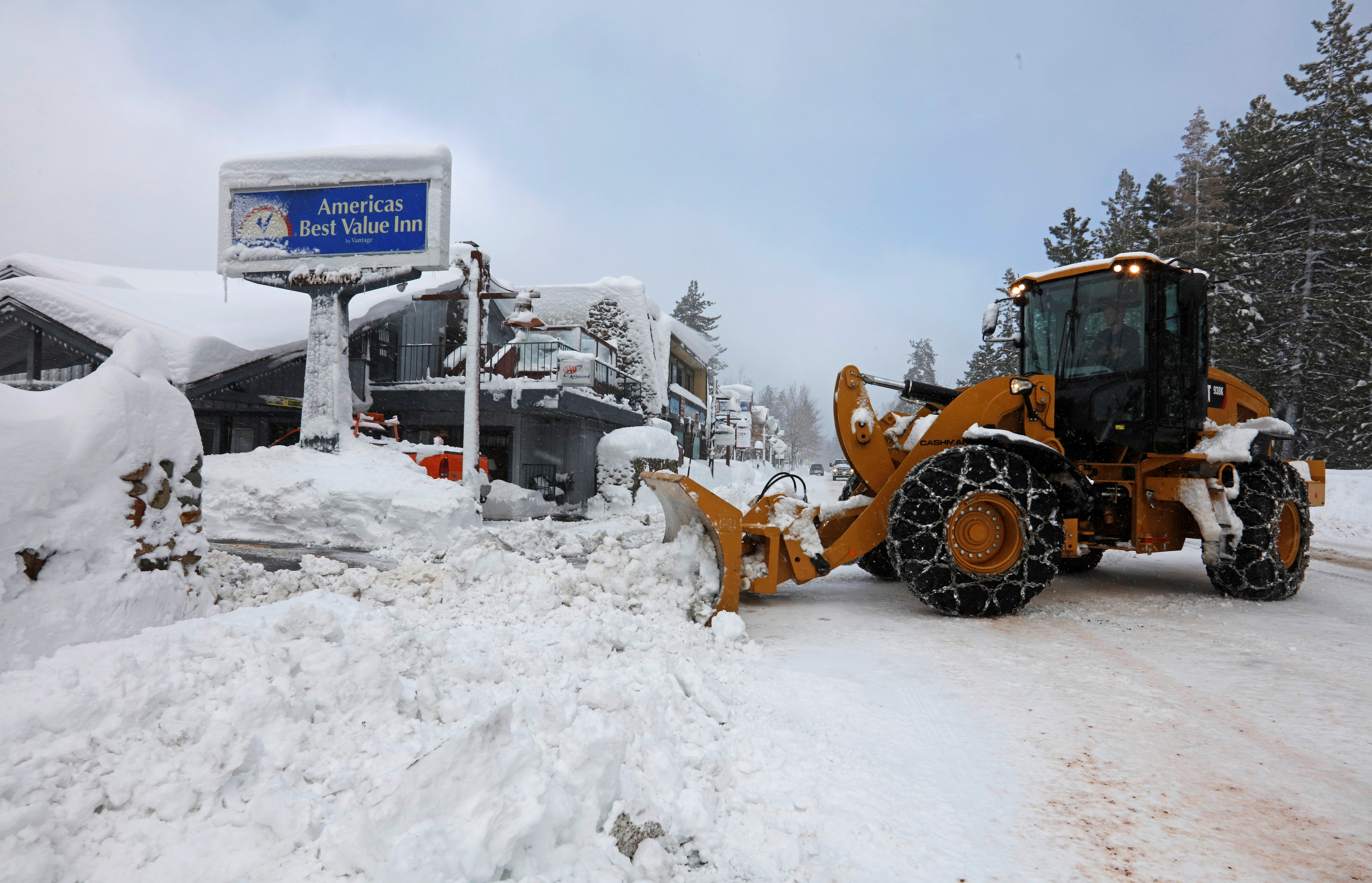 A plow clears snow after a heavy winter storm in Tahoe City, California.