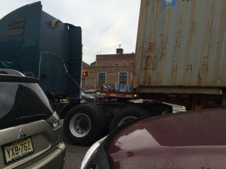 Hawkins Street School in Newark seen through the gap of a container truck. 