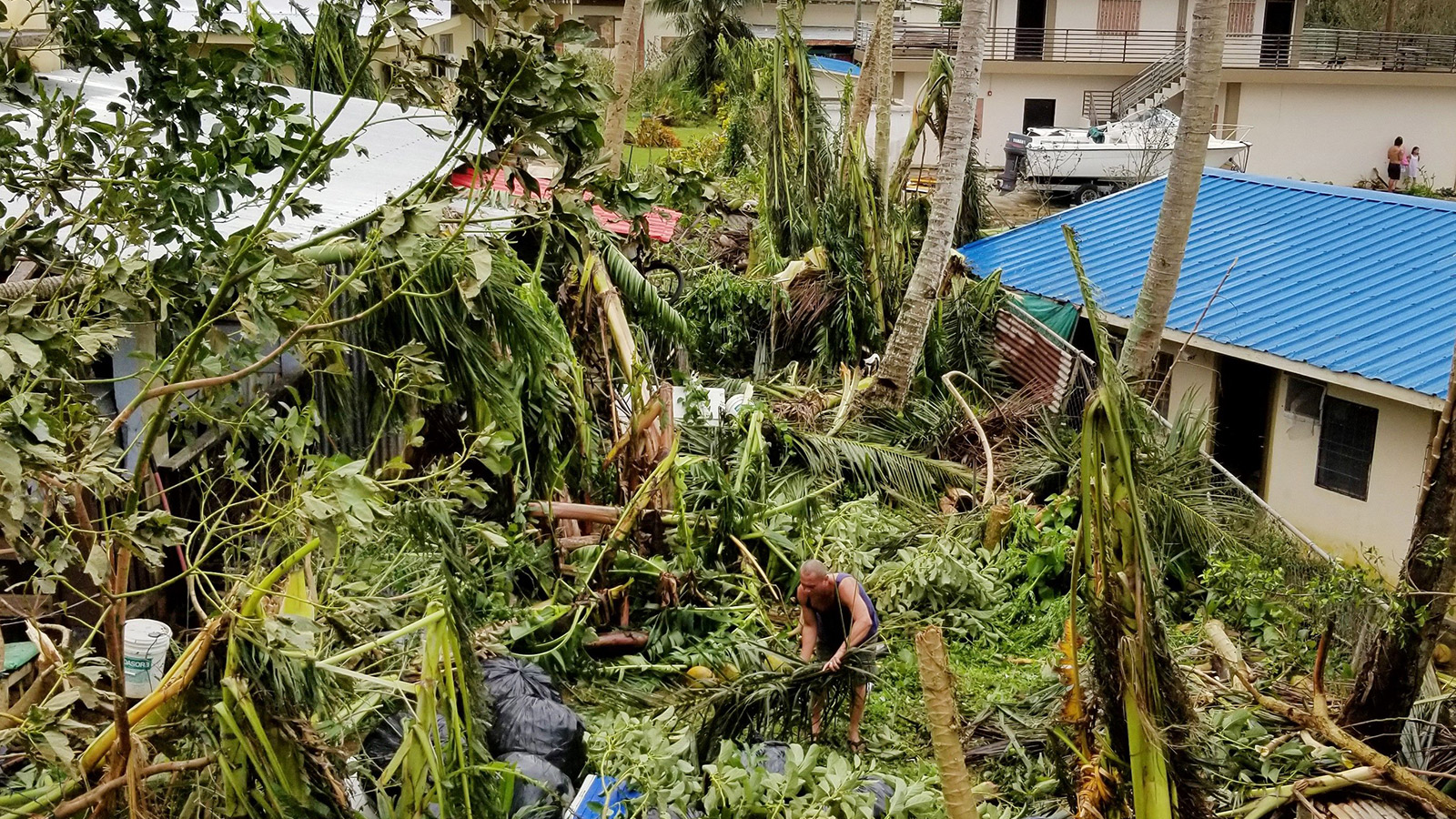 A resident clears up in Saipan after Super Typhoon Yutu caused widespread destruction across the islands of Saipan and Tinian