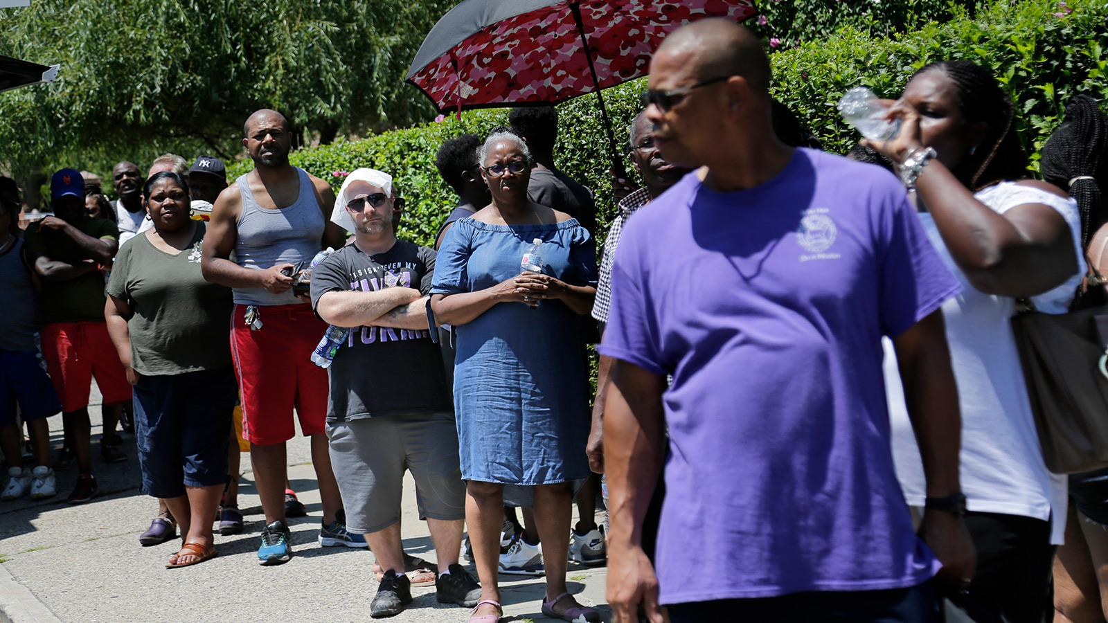 People line up to get dry ice from a Con Edison truck in a neighborhood without power in the Brooklyn borough of New York, Monday, July 22, 2019.