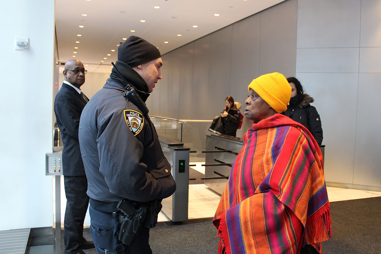 Carol Hemingway asking security if she could enter the building where the closed-door auction is being held.