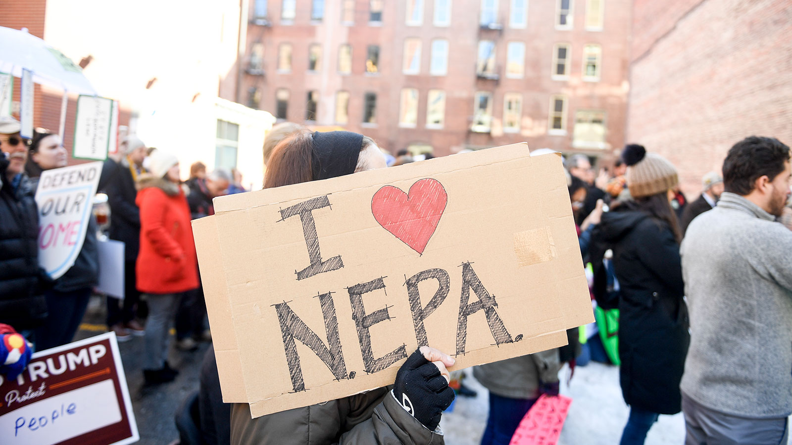 A protester holds up a sign that says 