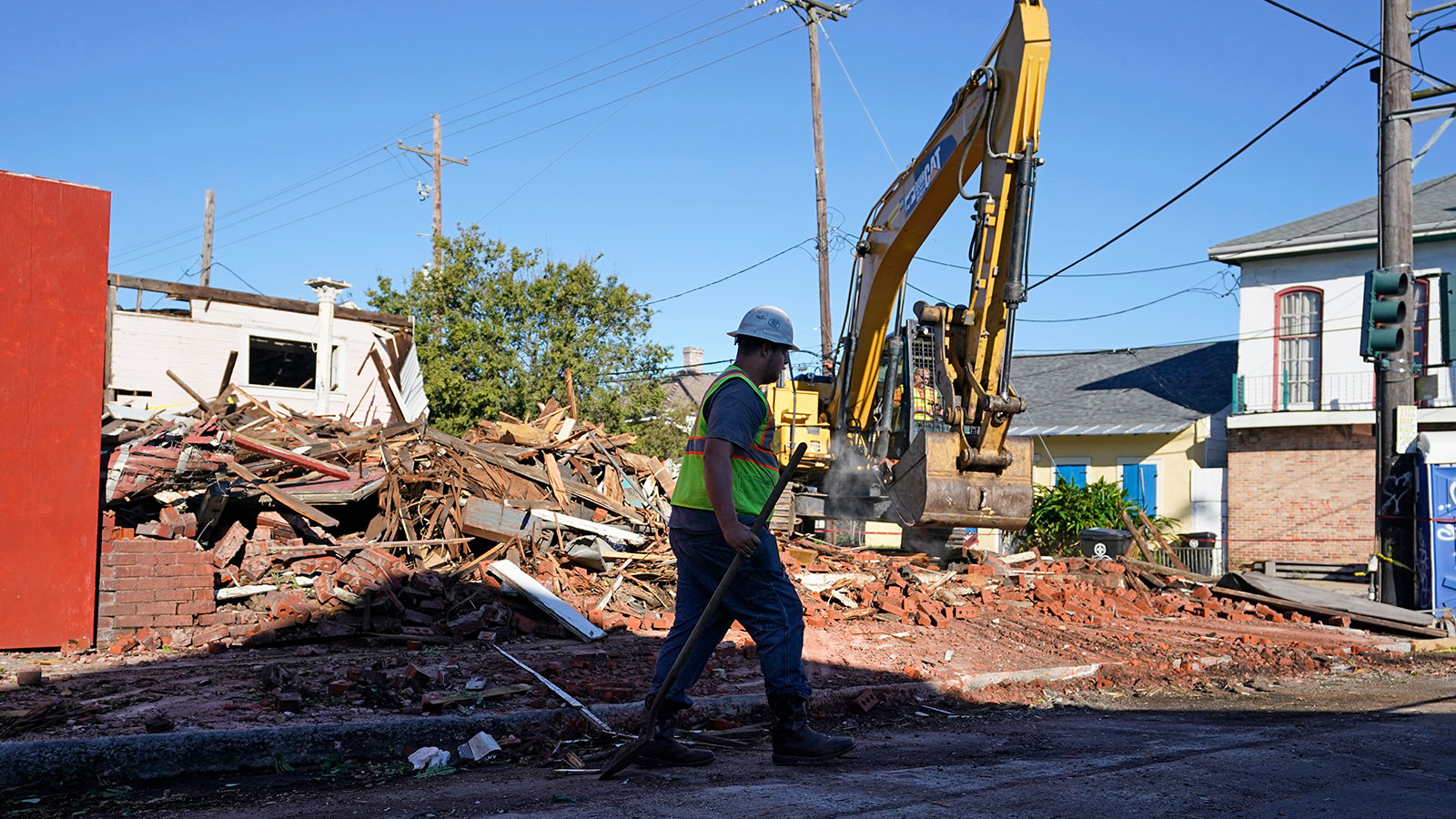 Workers remove debris from an unoccupied structure that collapsed yesterday as Hurricane Zeta passed through in New Orleans, Thursday, Oct. 29, 2020.