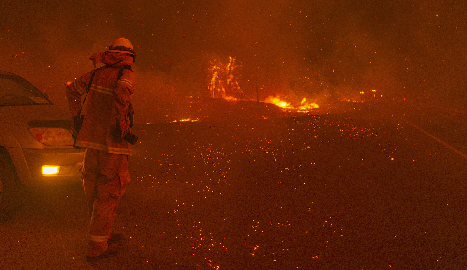 SHAVER LAKE, CA - SEPTEMBER 8: Embers fall around a photographer as the Creek Fire rapidly expands on September 8, 2020 near Shaver Lake, California. California Gov. Gavin Newsom declared a state of emergency in five California counties late yesterday as record heatwave temperatures fueled numerous wildfires over the Labor Day weekend. The state of emergency applies to Fresno, Madera and Mariposa, San Bernardino and San Diego counties. The Creek Fire has burned across more than 135,523 acres and is zero percent contained. (Photo by David McNew/Getty Images)