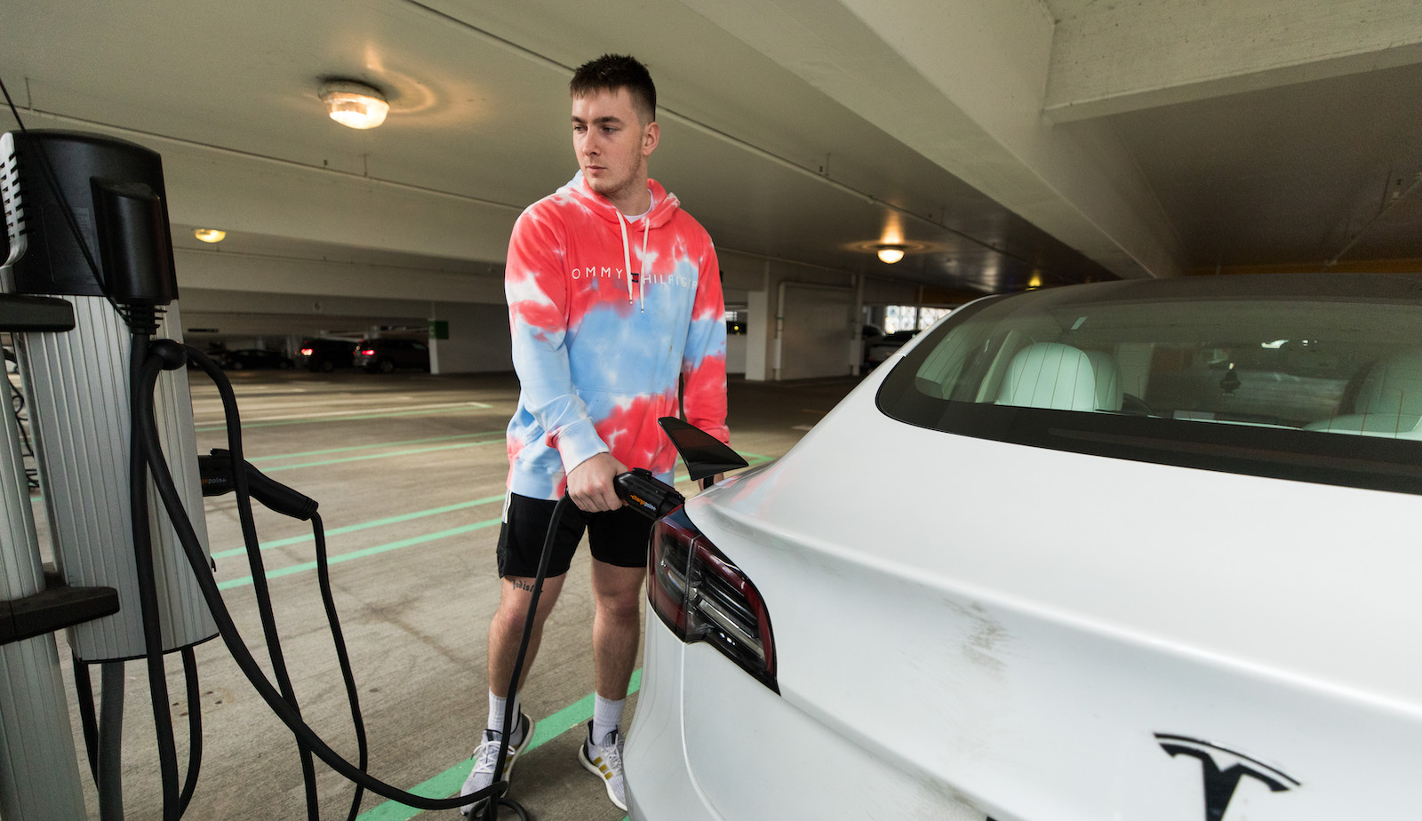 driver charging an electric car