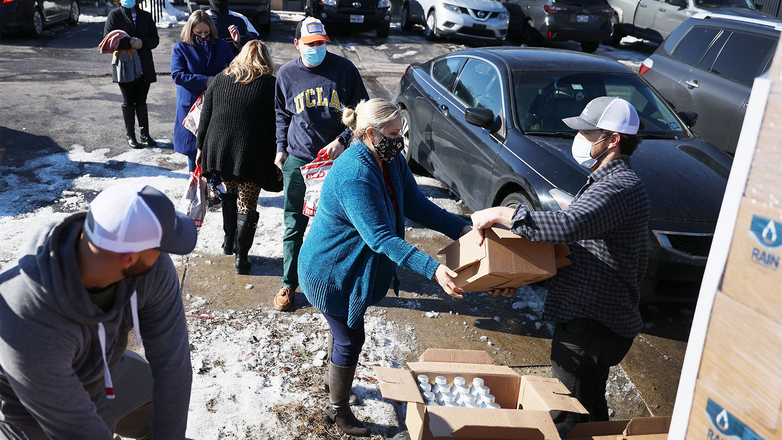 Mark Majkrzak gives out bottles of Rain Pure Mountain Spring Water to people in need on February 19, 2021 in Austin, Texas.