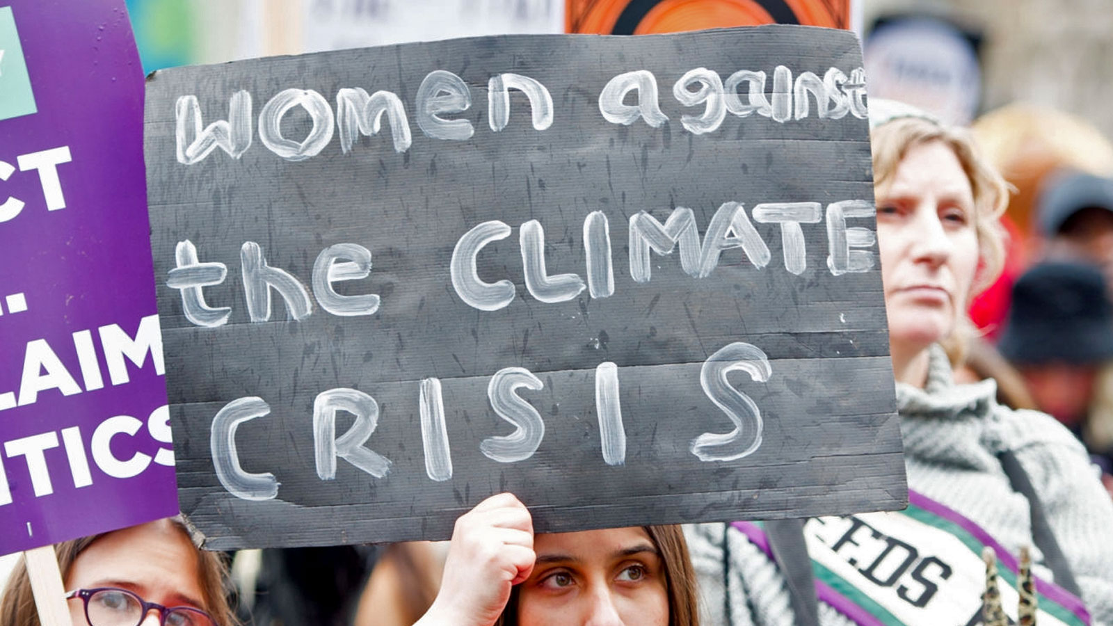 A woman holding a sign that says 