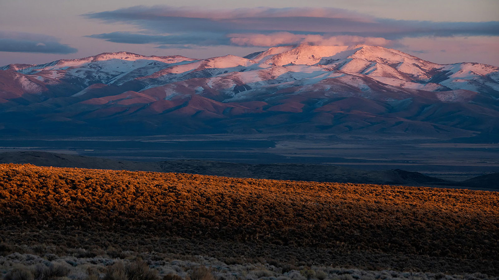 Thacker pass at sunset with snow-covered mountains in the background