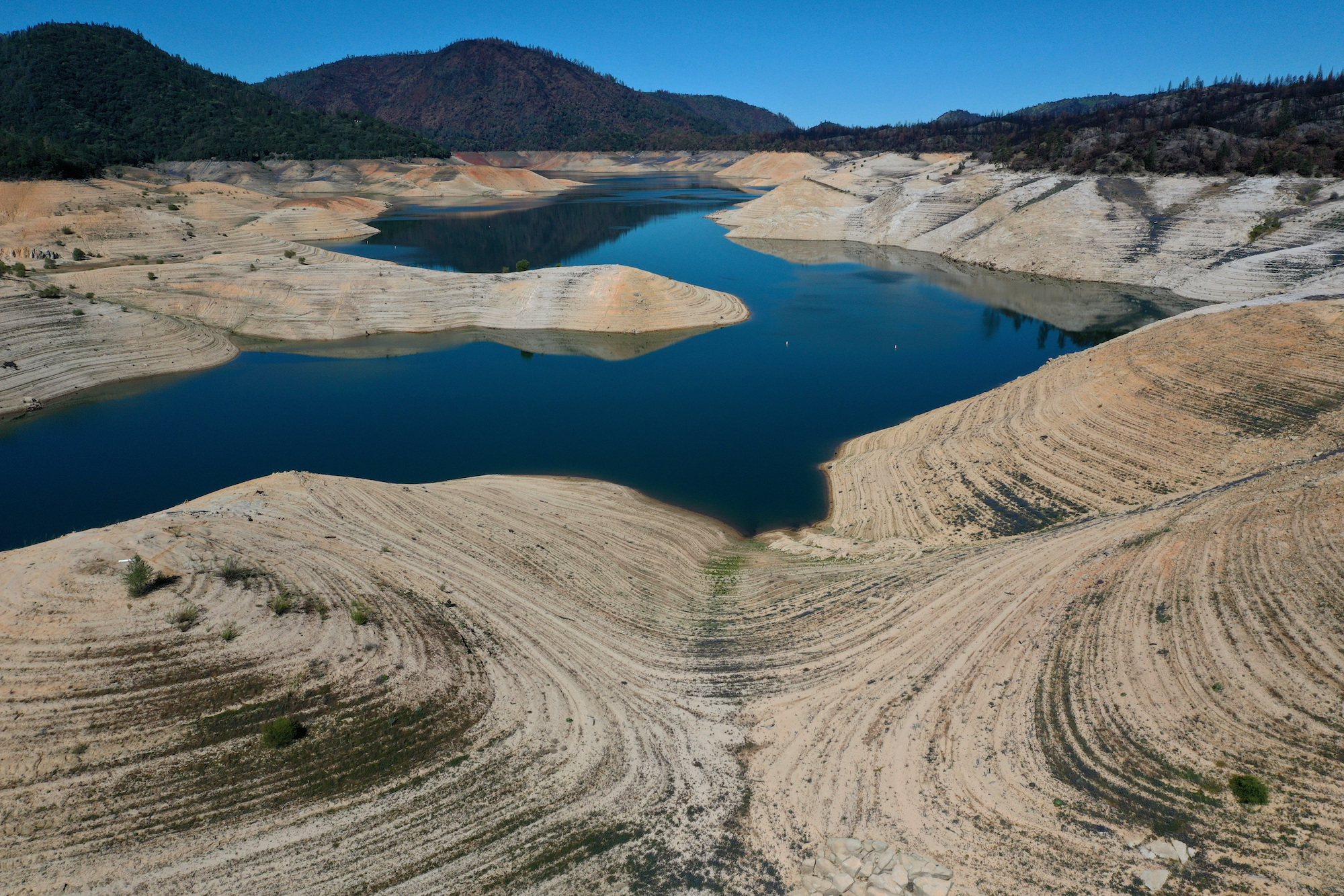 Four years after then California Gov. Jerry Brown signed an executive order to lift the California's drought emergency, the state has re-entered a drought emergency with water levels dropping in the state's reservoirs. Water levels at Lake Oroville have dropped to 42 percent of its 3,537,577 acre foot capacity. The lake is a sliver of blue between arid hills of exposed lakebed.