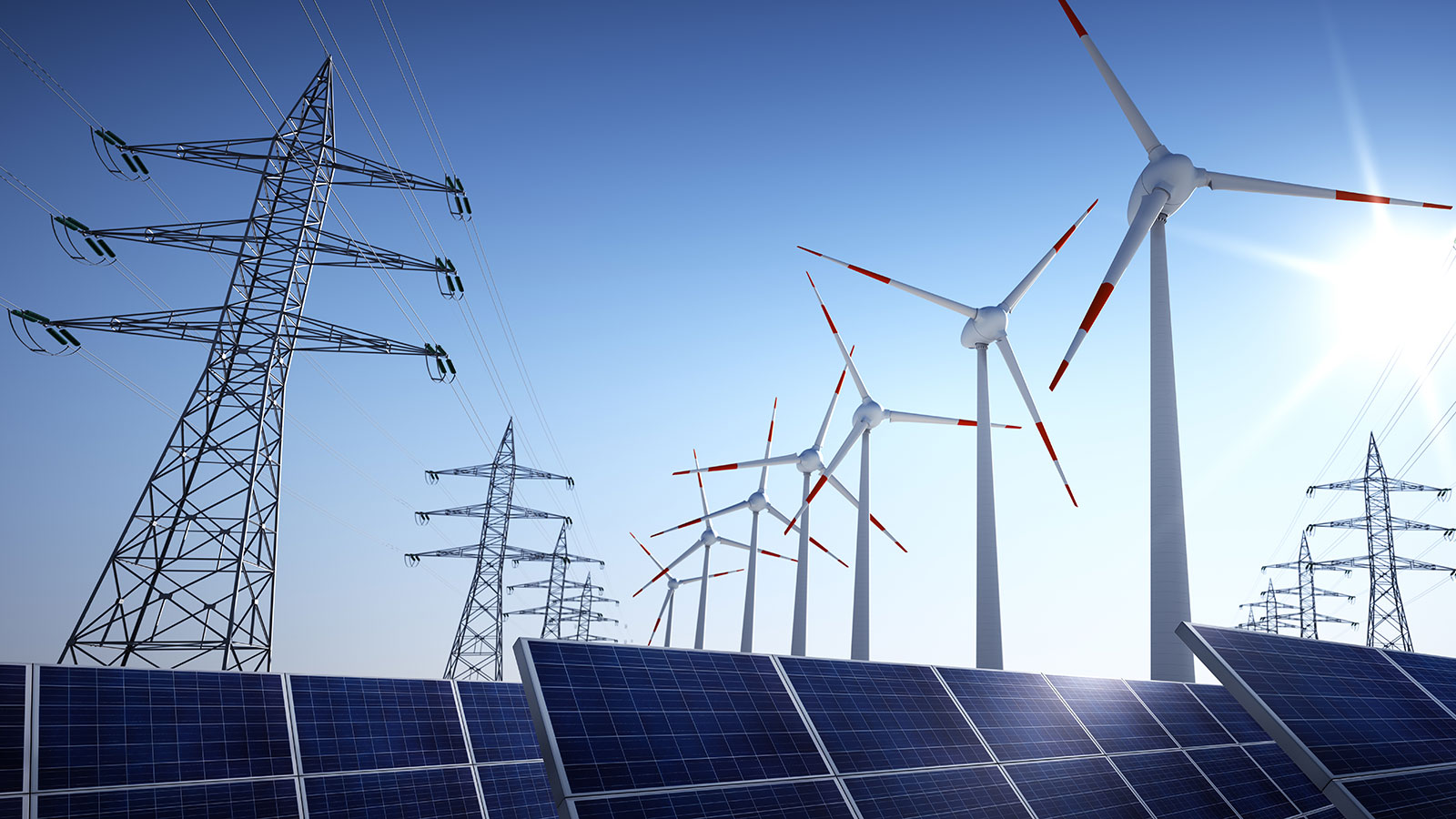 Low angle photograph of solar panels, wind turbines, and electric transmission towers