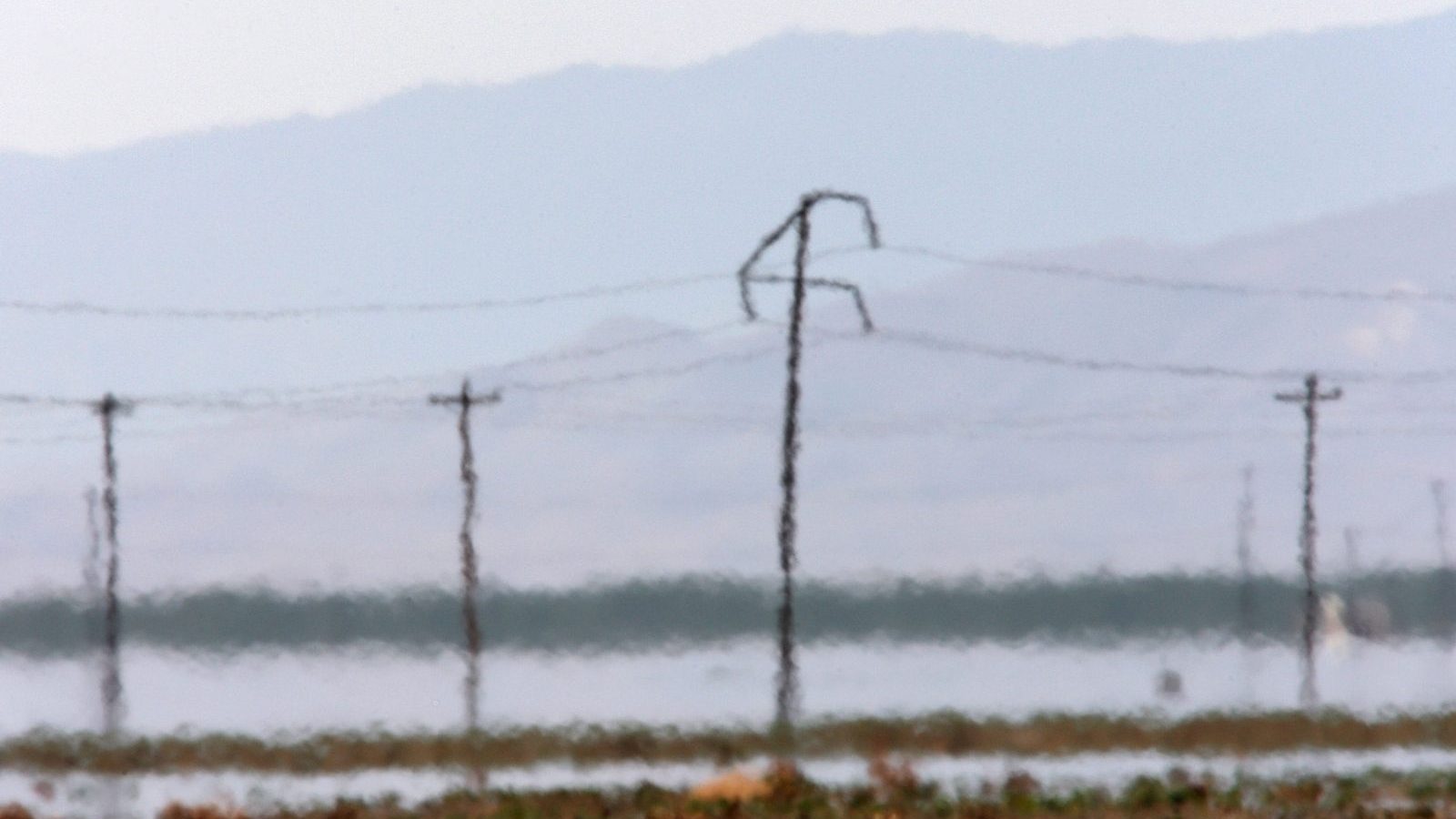 heat waves blurr power lines and hills