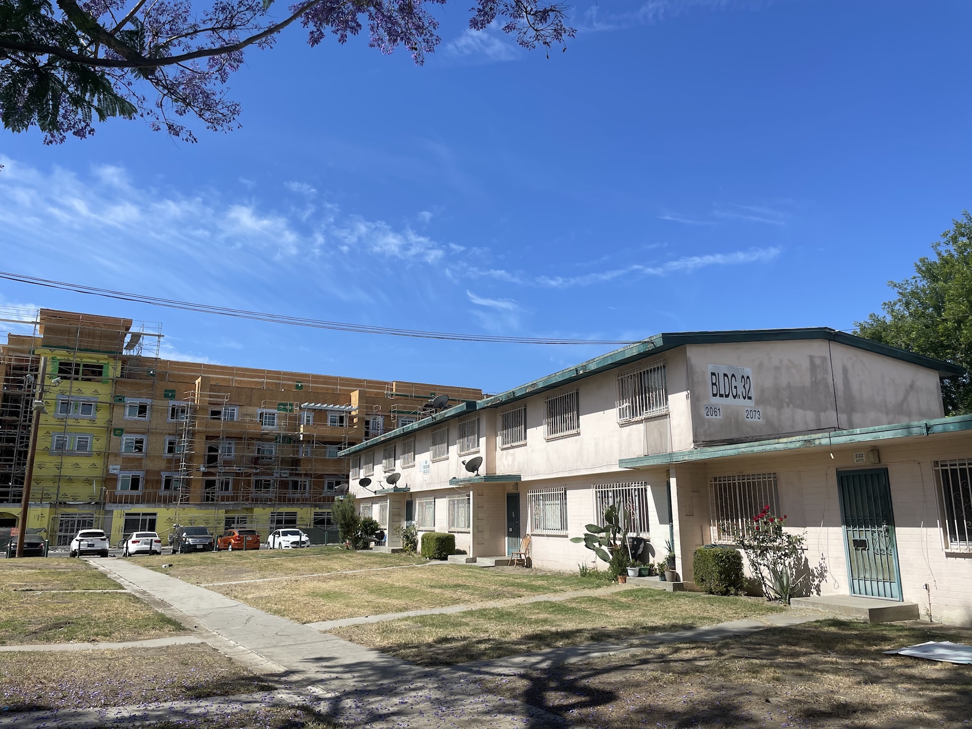 Jordan Downs public housing in Los Angeles with a new apartment building being constructed in the background.