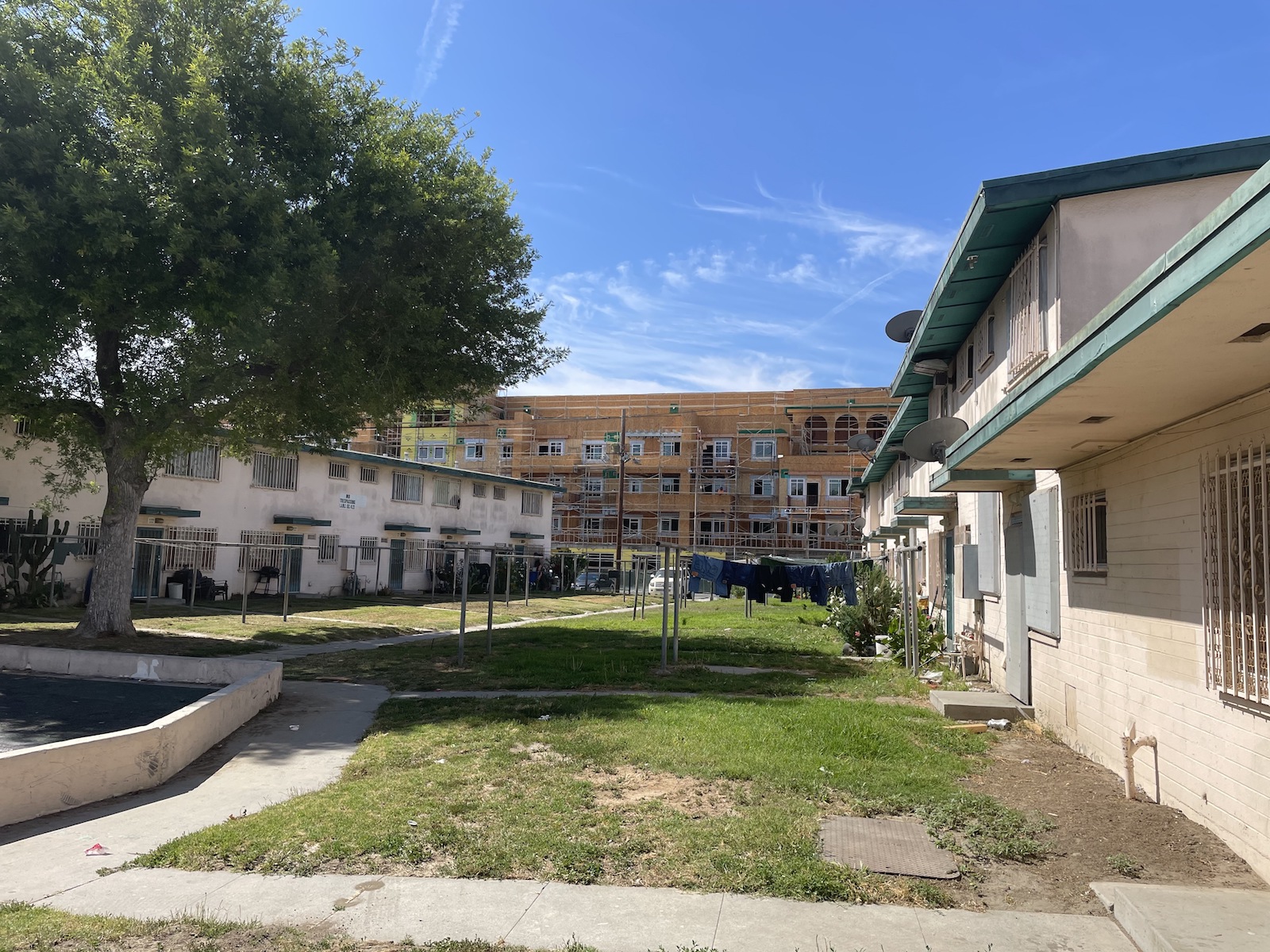 Jordan Downs public housing in Los Angeles with a new apartment building being constructed in the background.