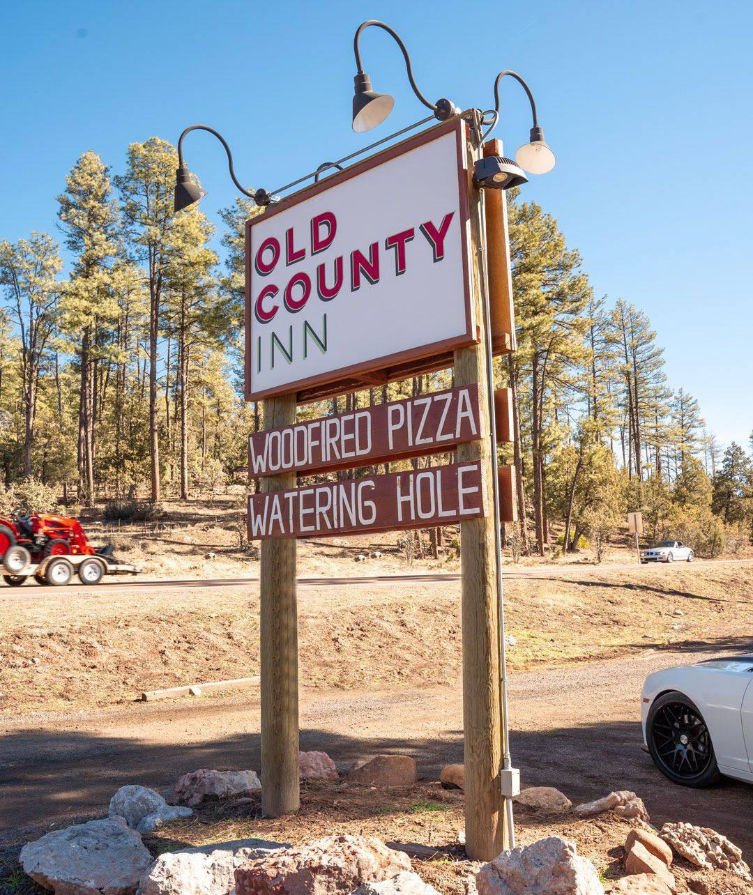 A large wooden sign that says old country inn