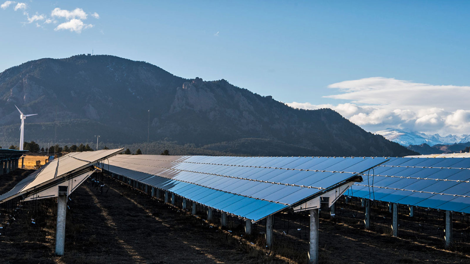 Solar panels with mountains in the background