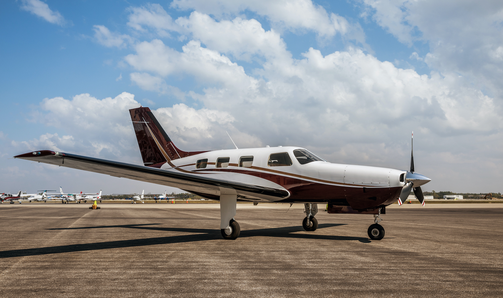 A small airplane rests on a runway.