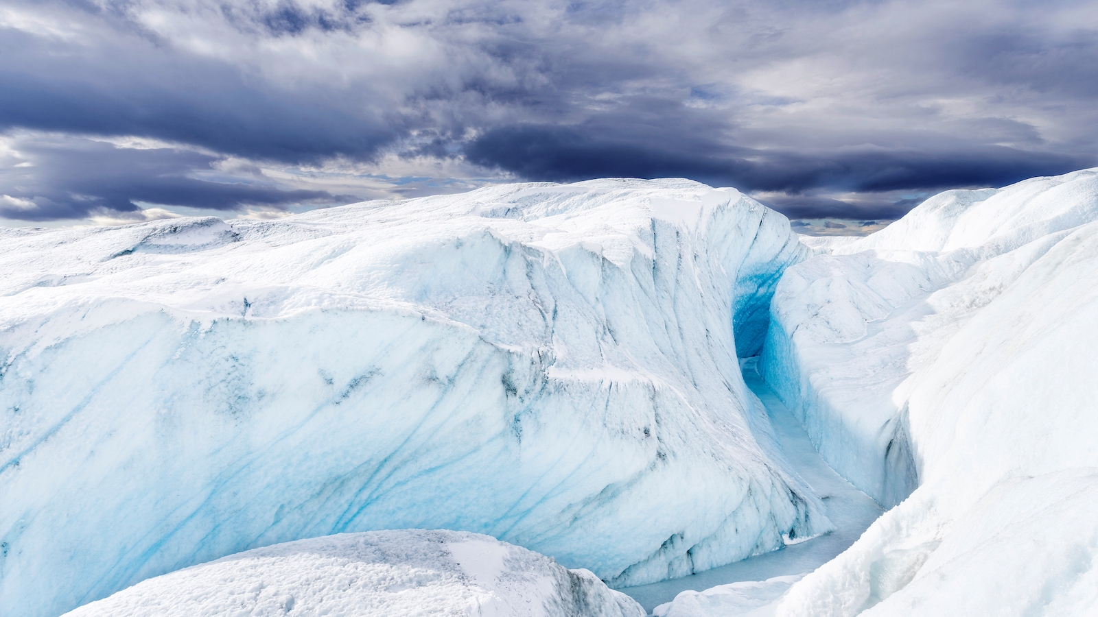 Meltwater carves channels in the ice.