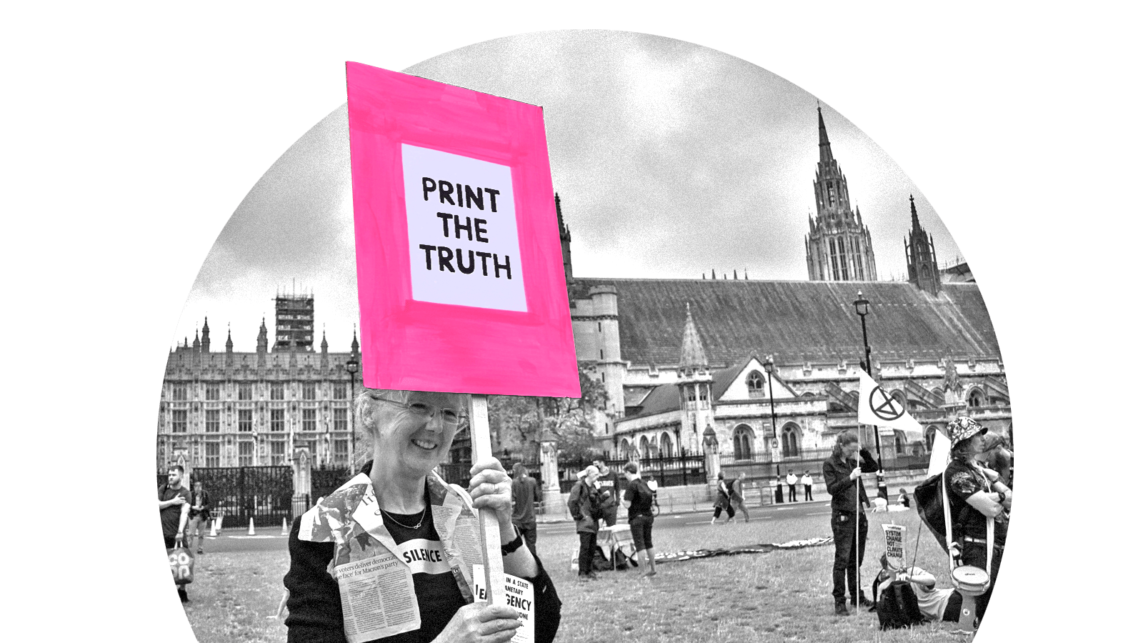 A woman at a protest holding a sign that says 