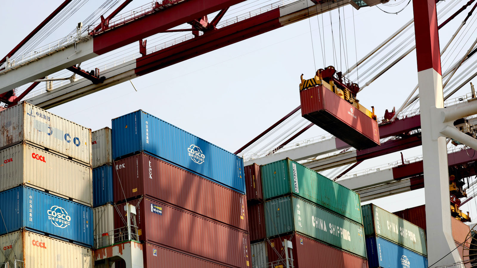 A shipping container is lifted from a cargo ship.