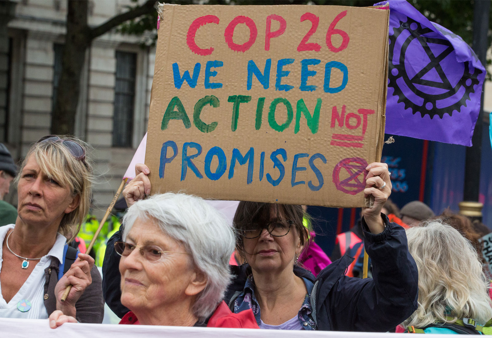 An activist holding a sign that reads 