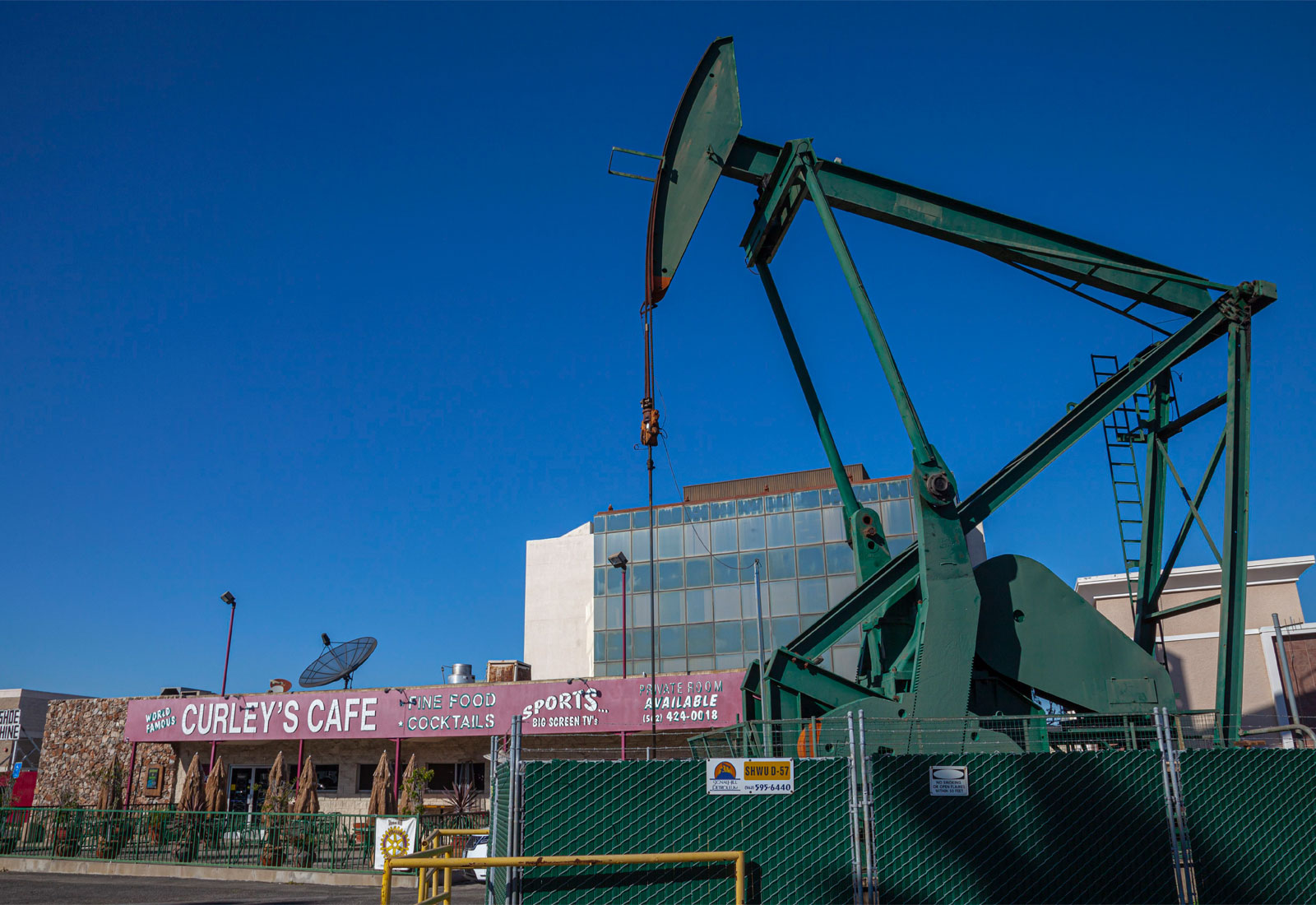 Oil pump jack in front of a restaurant