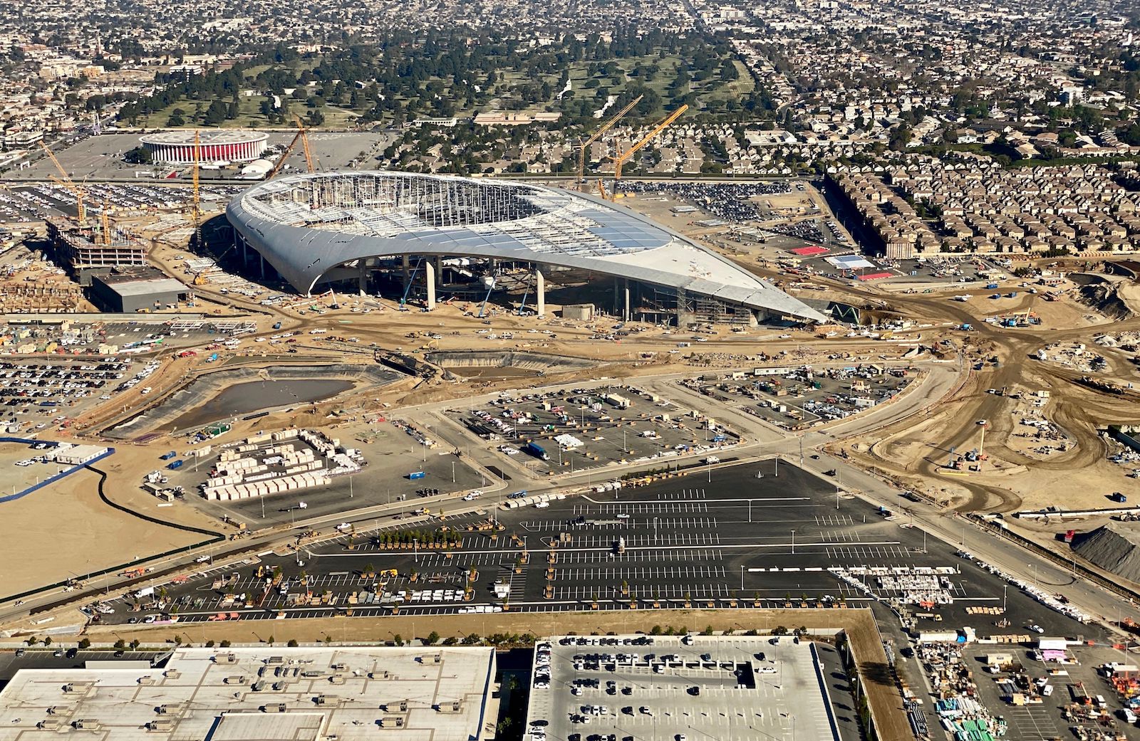 a silver stadium half-built in a dry area