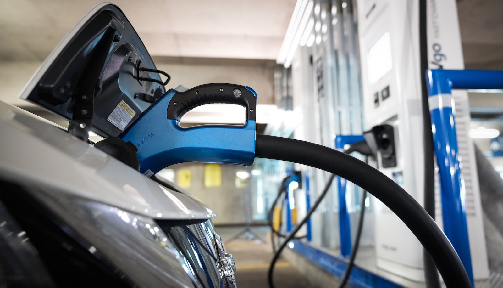 An electric vehicle plugged into a charging station.