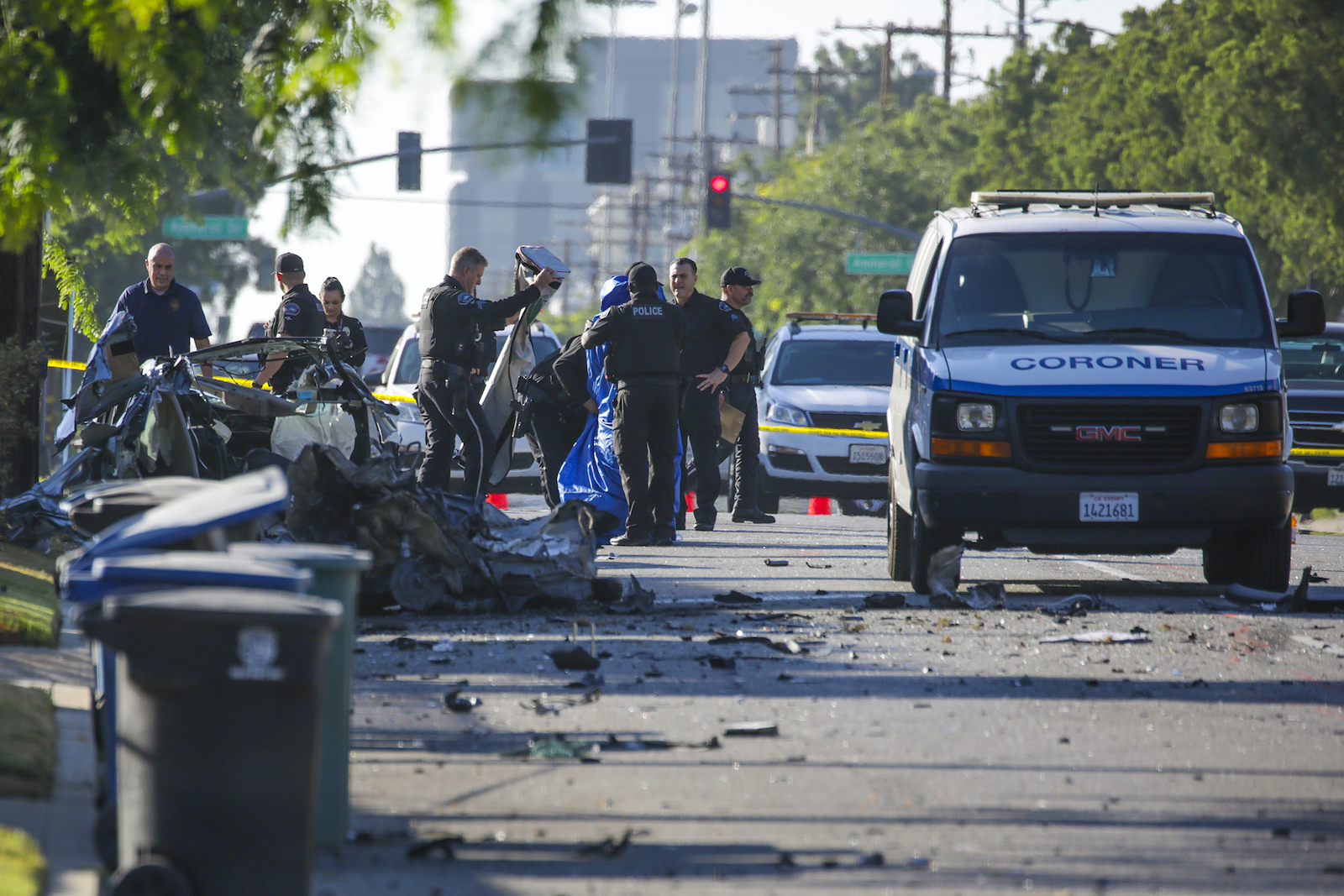 Police and the county coroner investigate a deadly car crash.