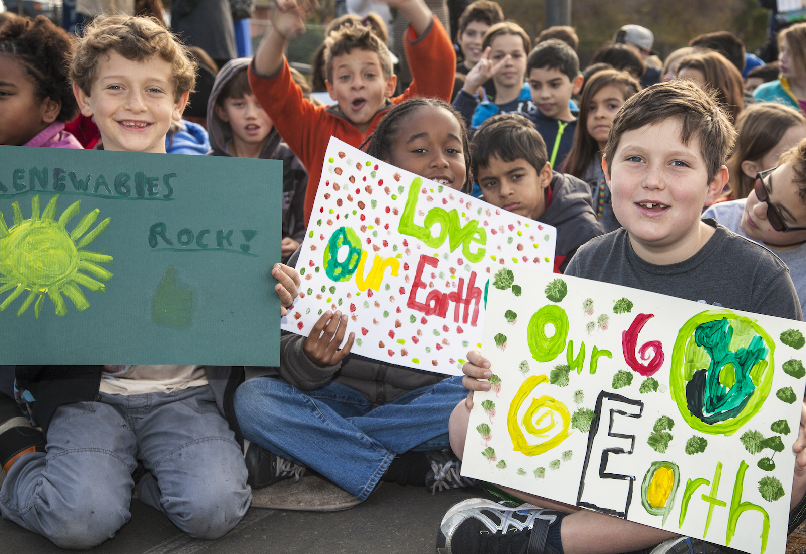 Students hold signs about climate change