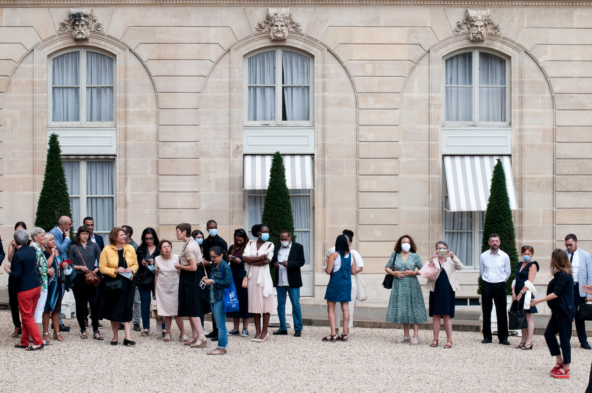 a group of people stand outside a government building