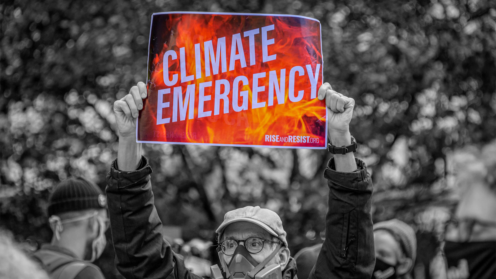 Man holding protest sign that says 