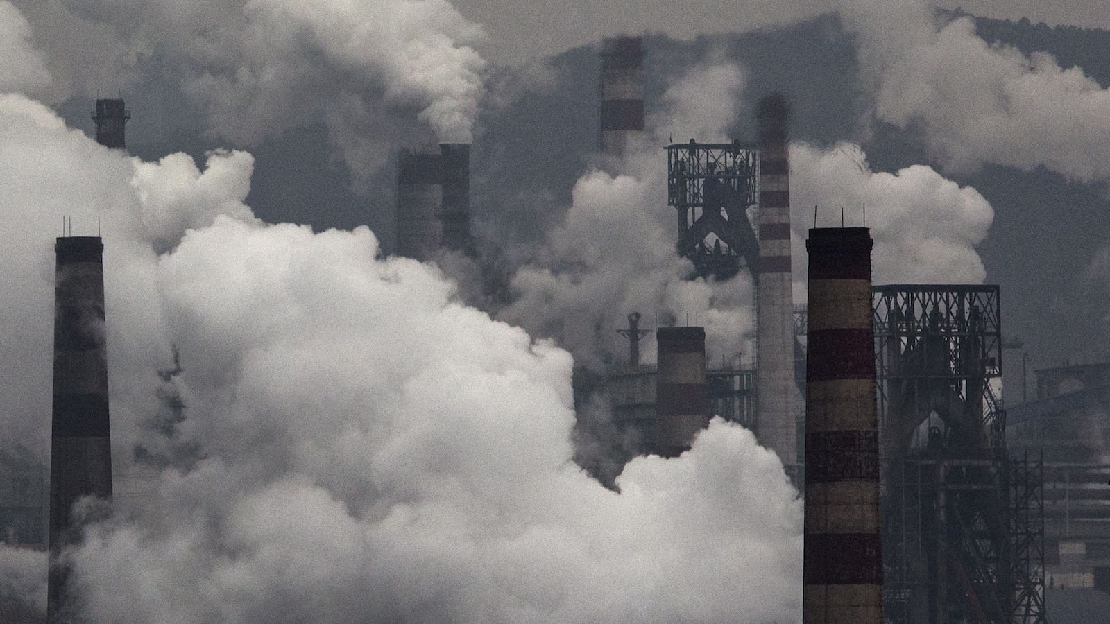 Smoke billows from smokestacks