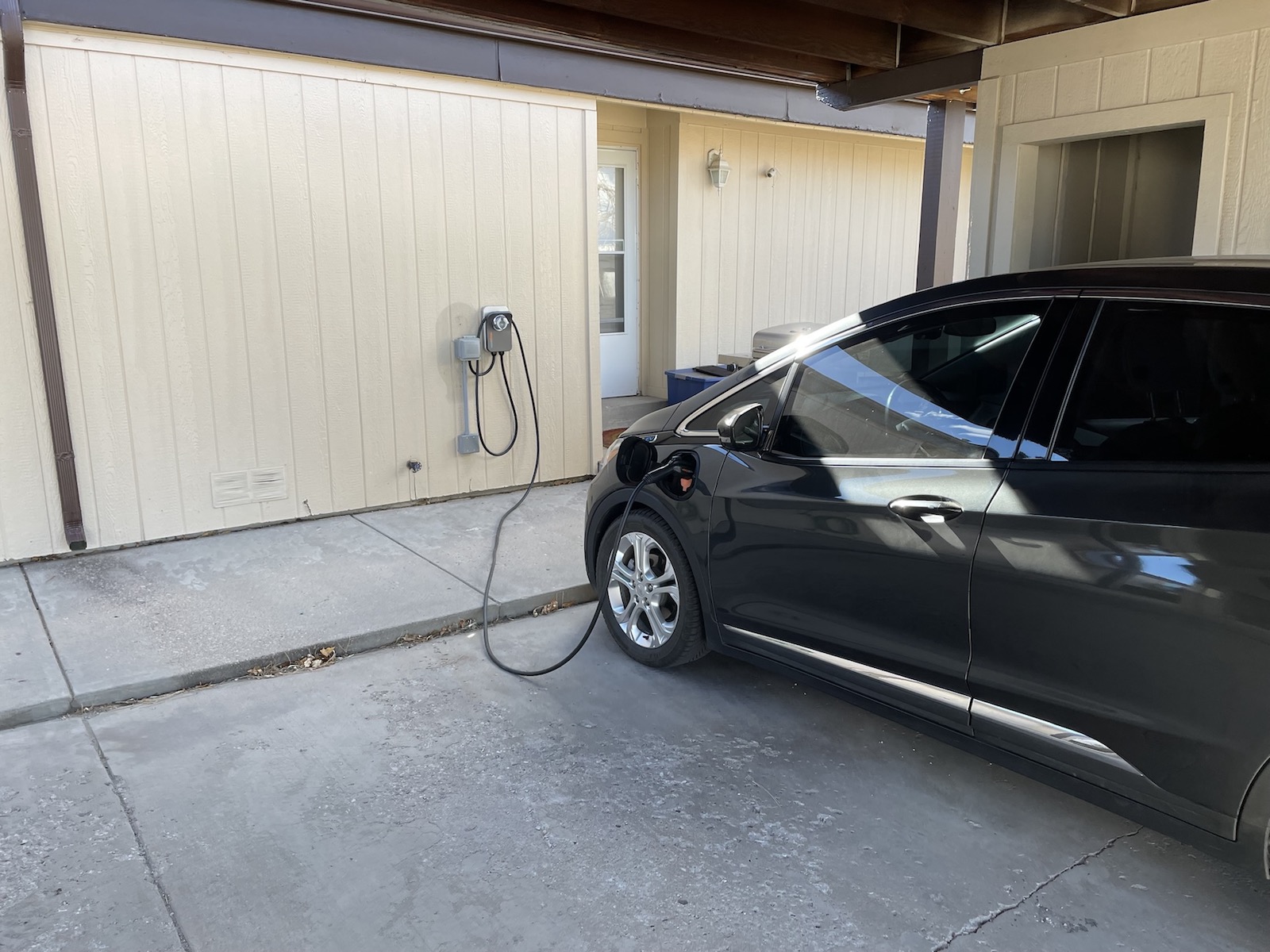 a gray electric car packed into a wall unit