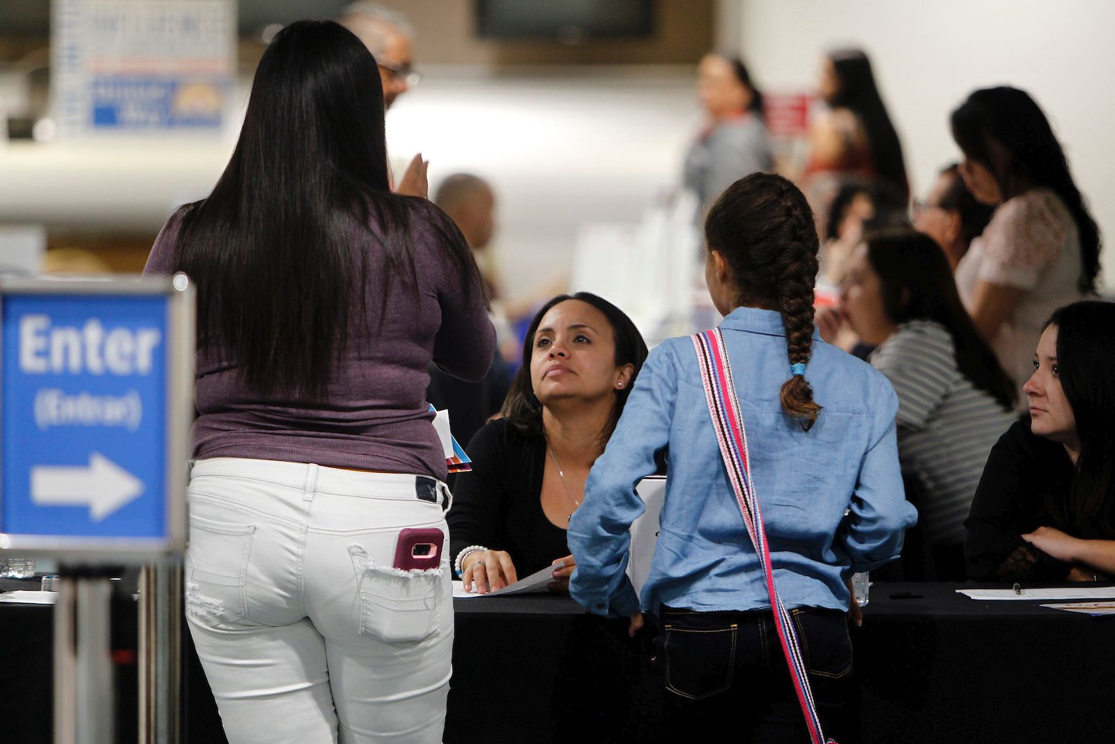 People wait at an information center.