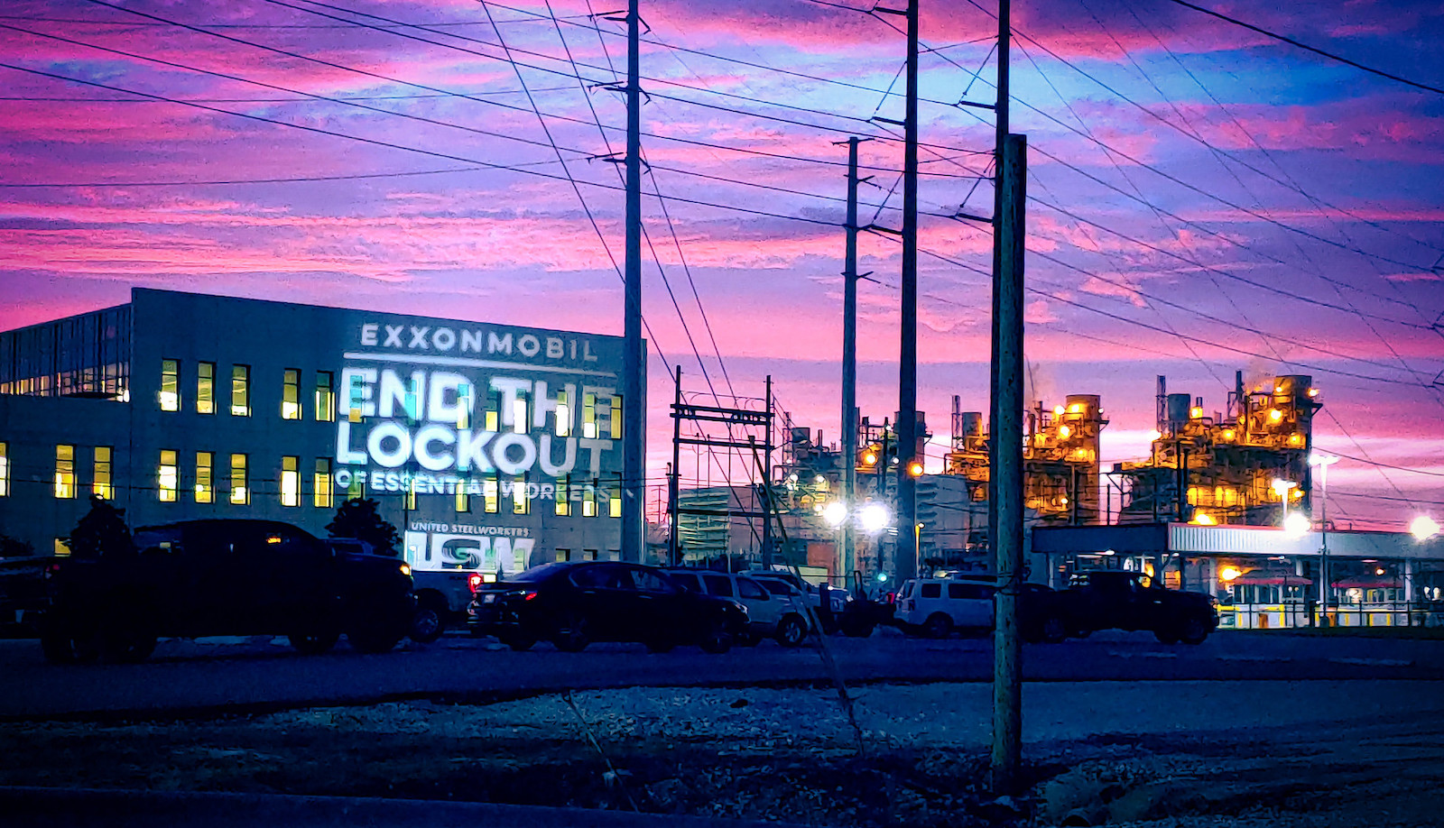 Oil refinery in texas lit up at night. The words 