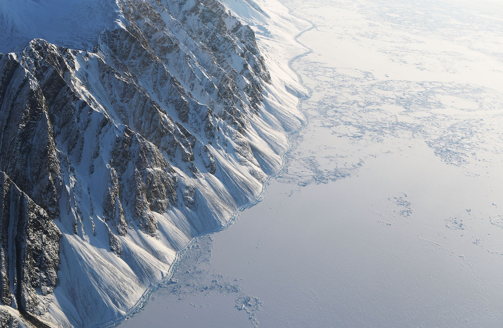 Sea ice (R) is seen from NASA's Operation IceBridge research aircraft on March 29, 2017 above Ellesmere Island, Canada.