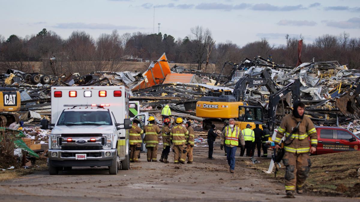 Emergency crews search through the flattened Mayfield Consumer Products building on December 11, 2021 in Mayfield, Kentucky.